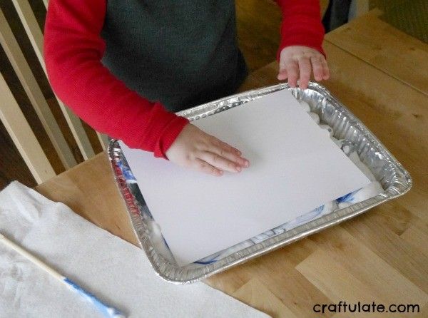 Winter Sky Art for Kids - using a marbling technique and paper punches!