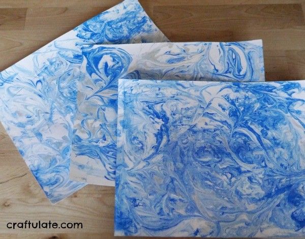 Winter Sky Art for Kids - using a marbling technique and paper punches!