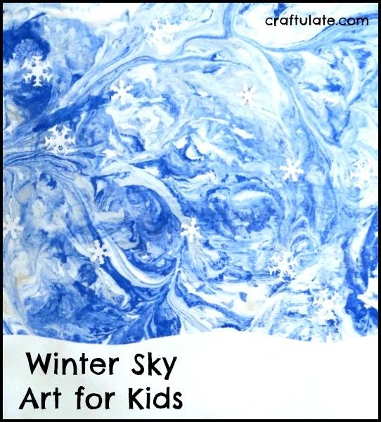 Winter Sky Art for Kids - using a marbling technique and paper punch snowflakes!